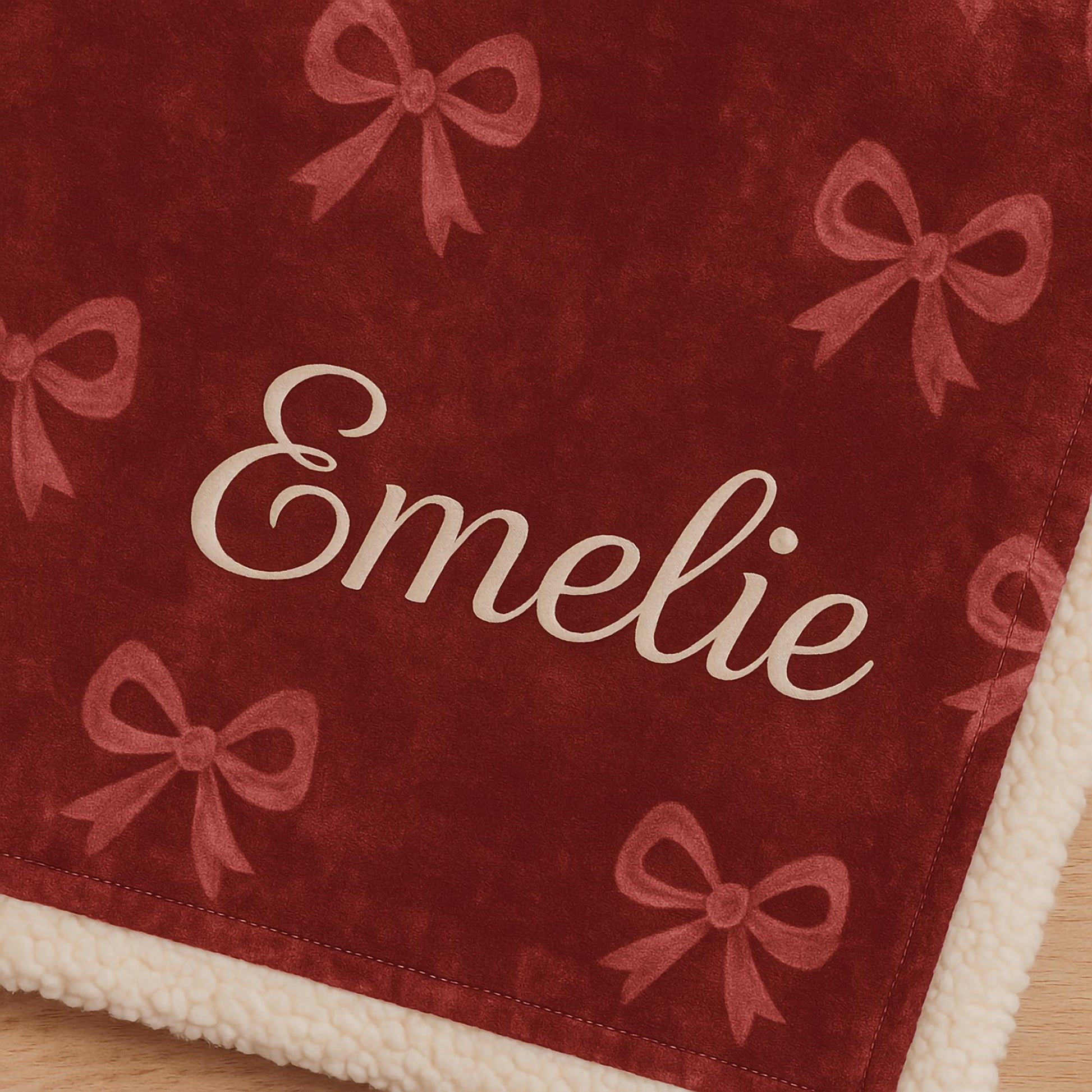 Personalized red velvet blanket with embroidered name Emelie, custom bow design, sherpa lining, monogrammed holiday gift
